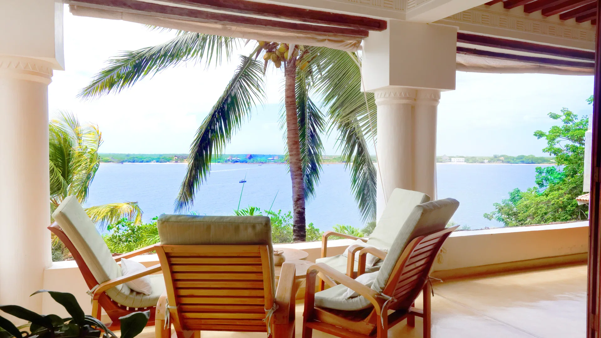 Chairs on a shaded veranda overlooking the ocean at Peponi Hotel in Lamu
