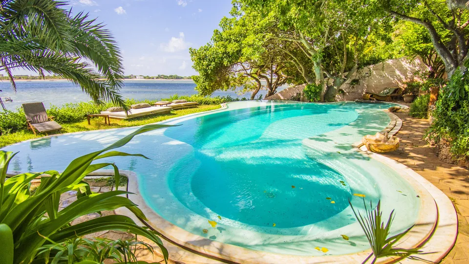 Pool and shaded gardens overlooking the Indian Ocean at Peponi Hotel, Lamu, Kenya
