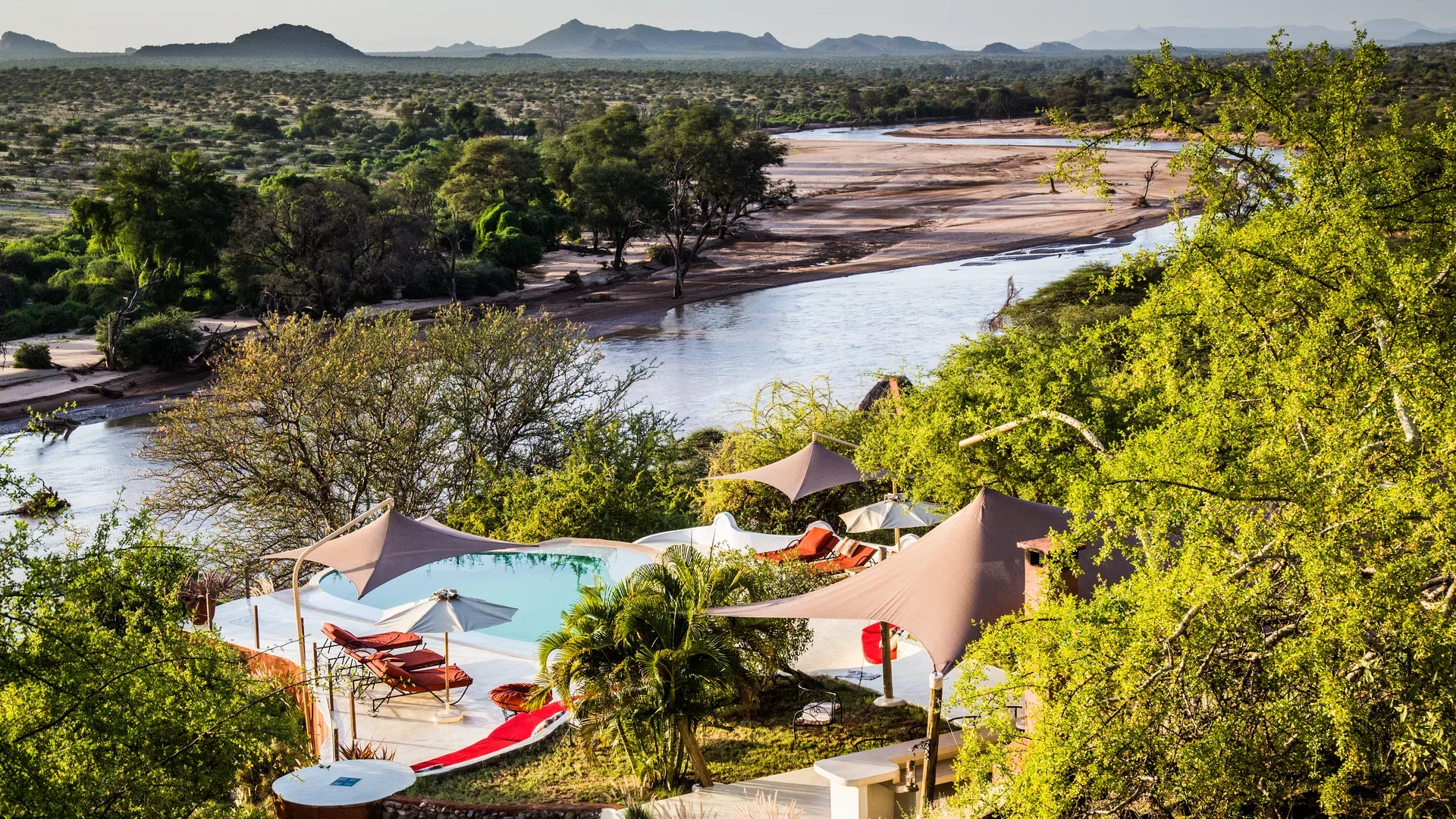 Aerial view of Sasaab Lodge pool overlooking the Ewaso Nyiro River and Samburu landscape in Kenya.