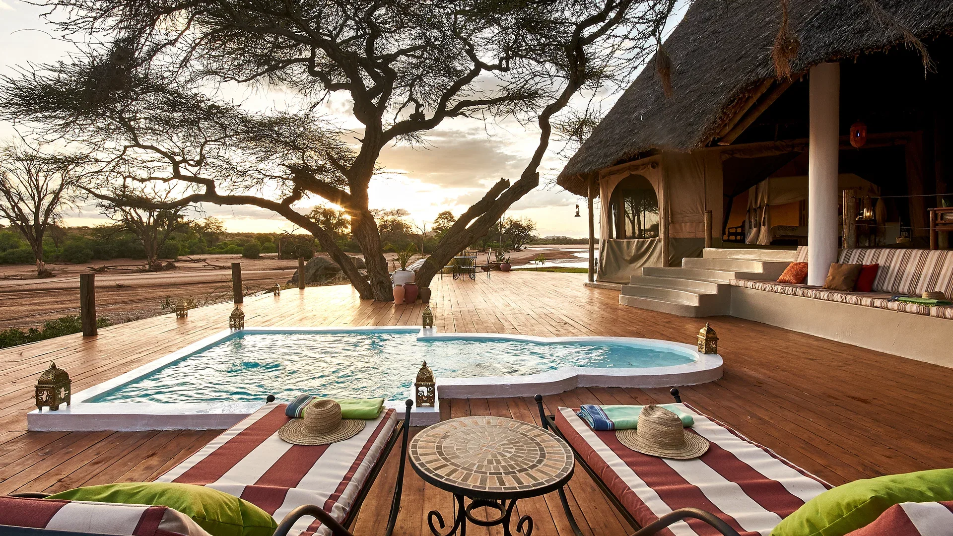Private plunge pool and sun loungers on a deck at Sasaab Lodge overlooking the Samburu landscape.