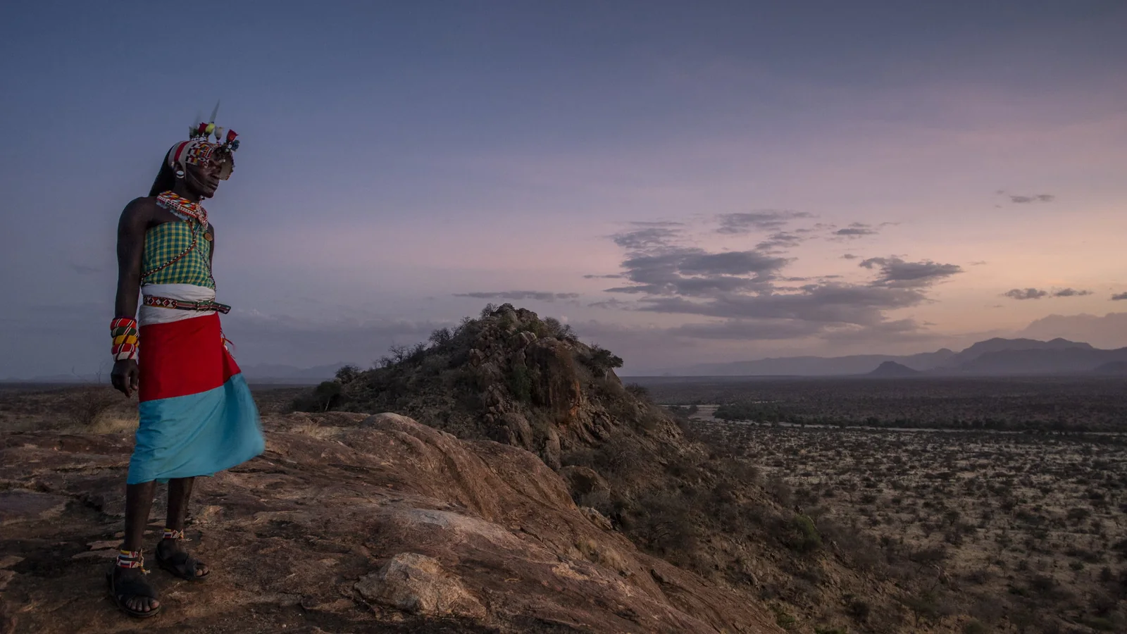 Guests watching sunset from a rocky viewpoint in Samburu