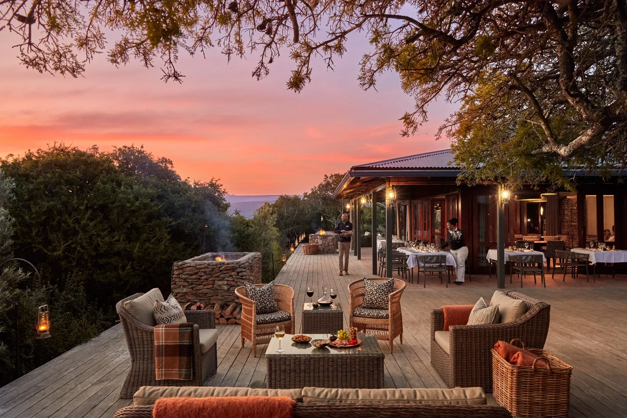 Outdoor lounge and dining terrace at Kwandwe Ecca Lodge at sunset