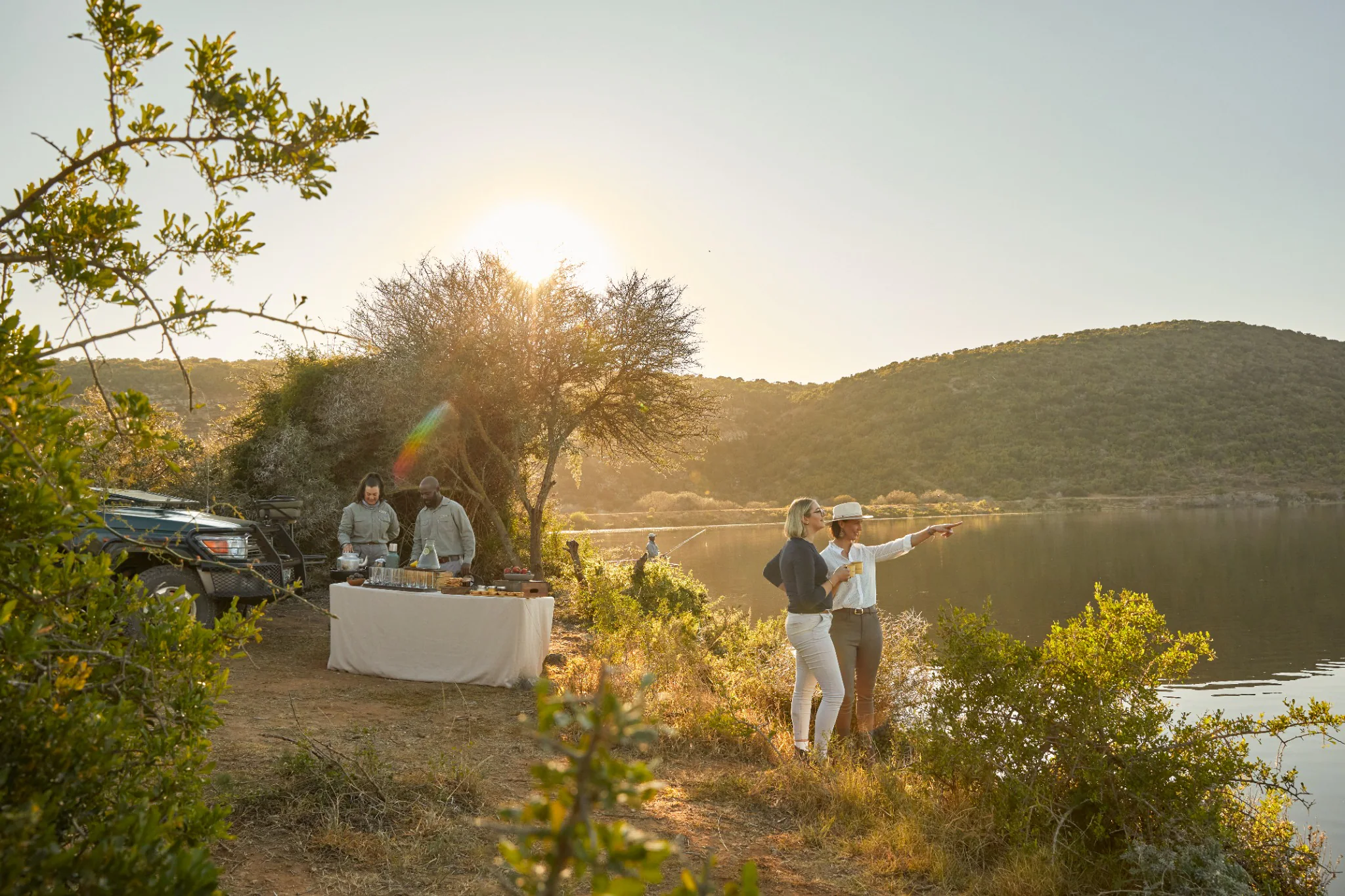 Two guests enjoying a riverside safari stop at Kwandwe Private Game Reserve