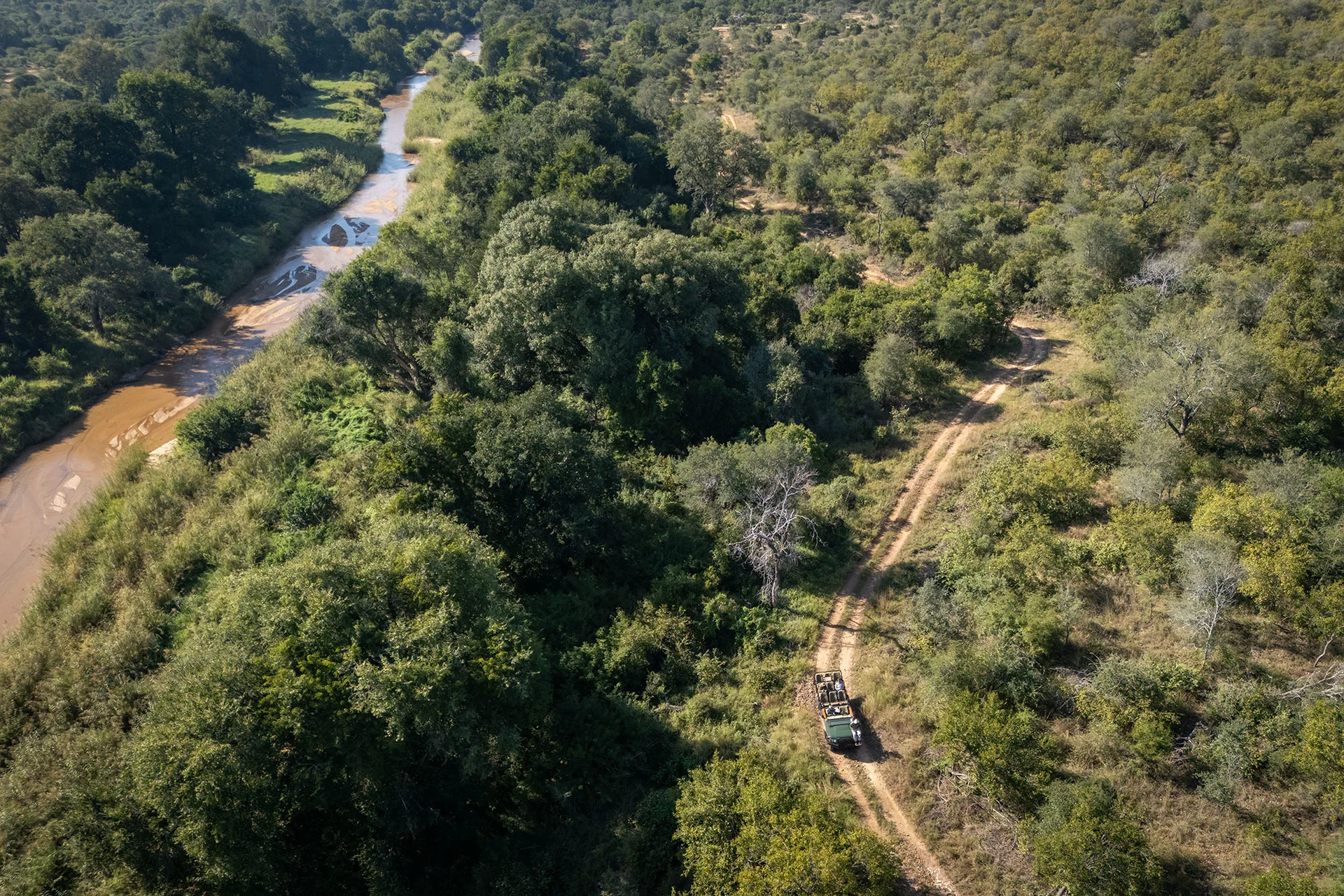 Safari vehicle travelling beside the river in Karongwe Private Game Reserve