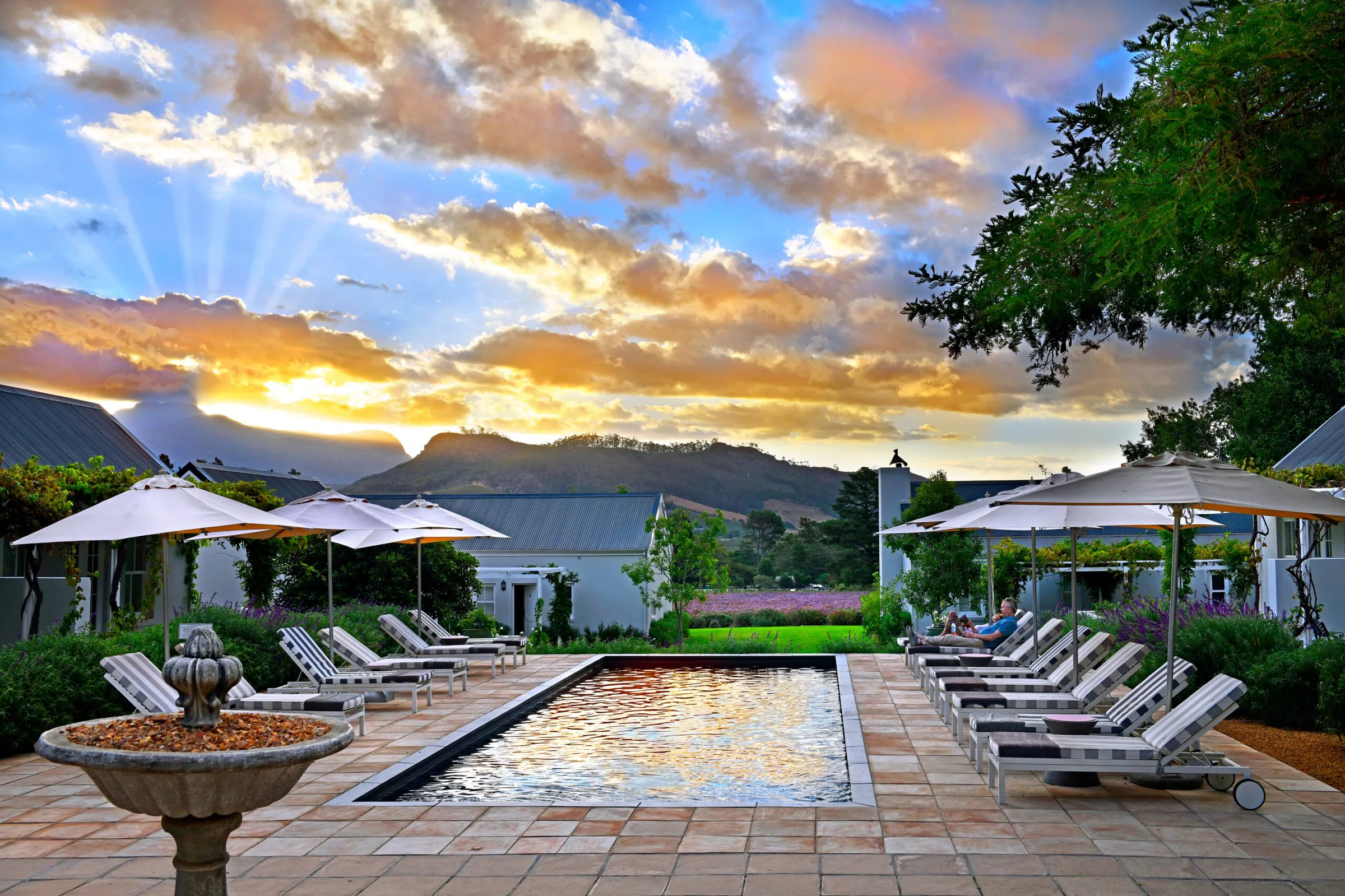 Pool at Lavender Farm Guest House with mountain views at sunset in Franschhoek, South Africa