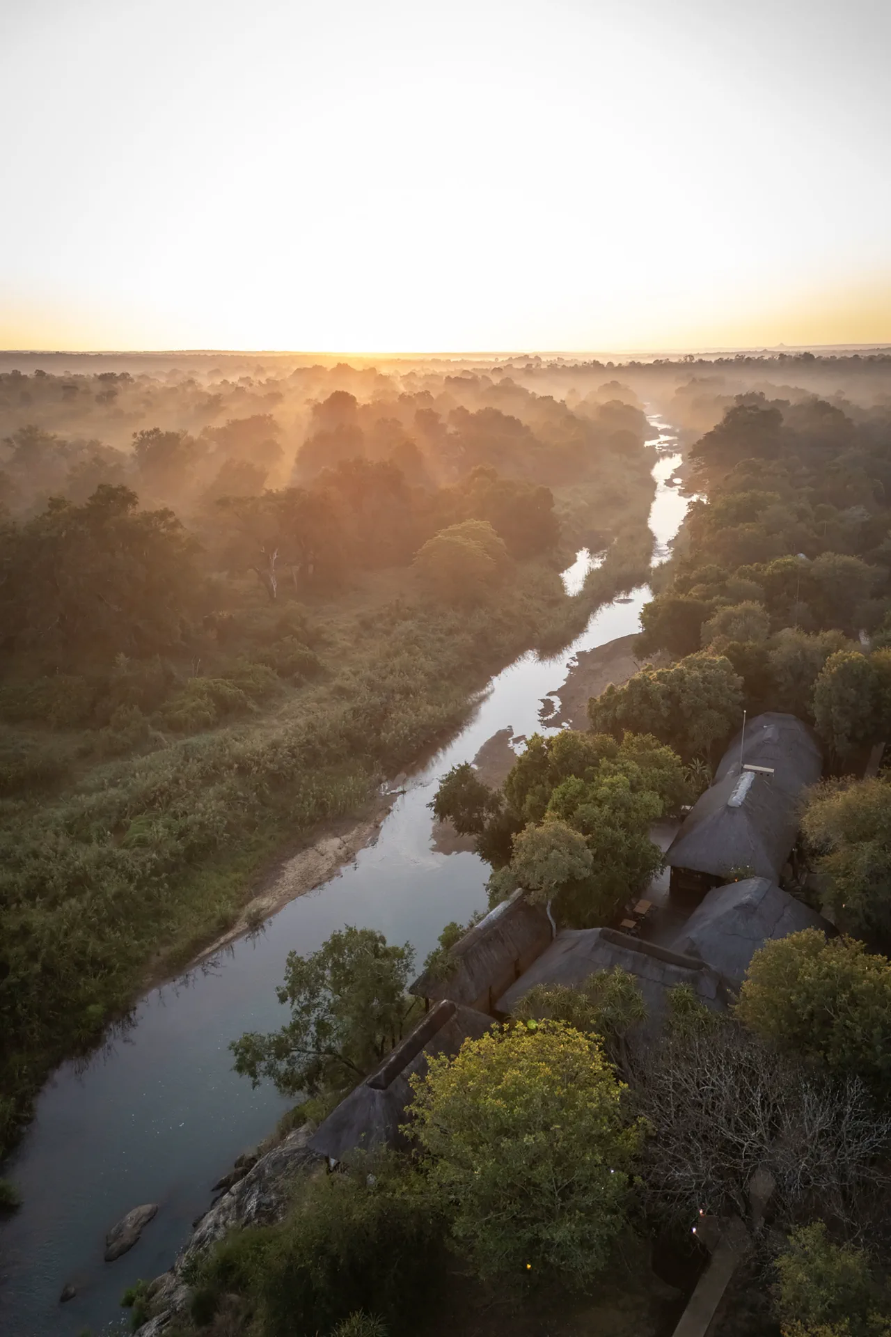 Aerial view of River Safari Lodge beside the Makhutswi River at sunrise