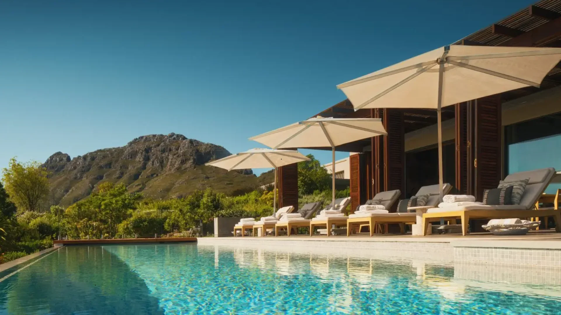 Pool terrace overlooking vineyards and mountains at Delaire Graff Estate