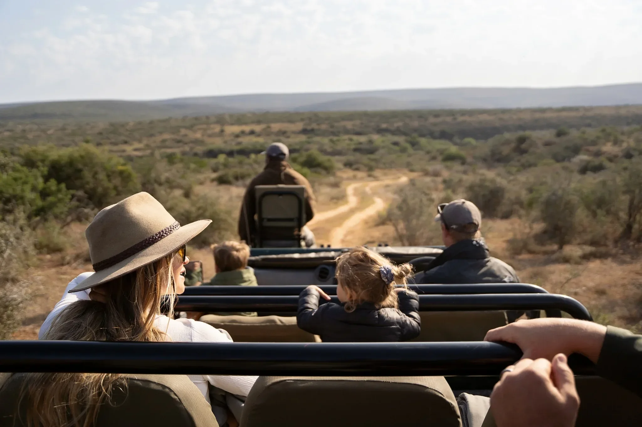 Family sharing an open-vehicle safari at Kwandwe Private Game Reserve