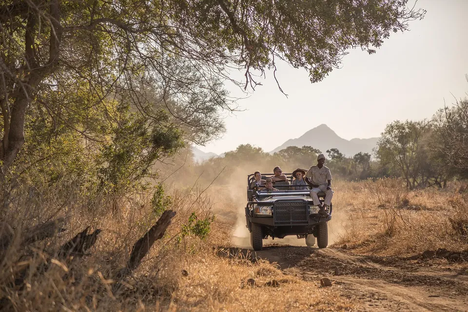 Open safari vehicle in the Karongwe landscape at golden hour